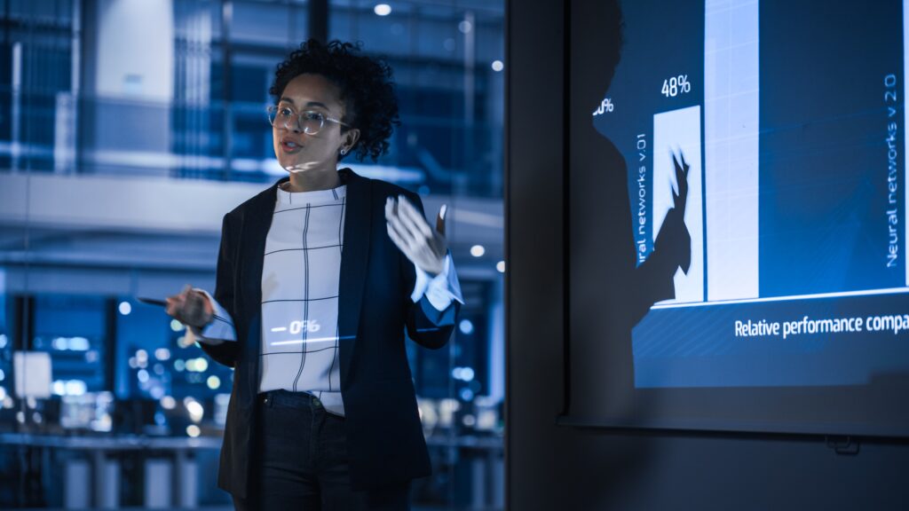 Woman standing in front of a data presentation | FourthRev