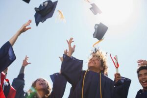 university graduates through hats in the air